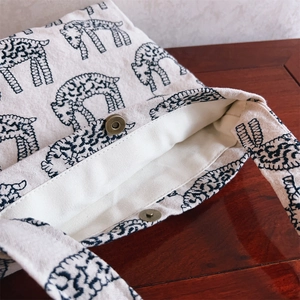 Detail of the vintage bronze magnetic clasp and canvas lining on the white sheep tote bag