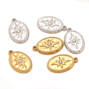 Oval stainless steel starburst pendants with small rhinestones in gold and silver