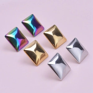 Detailed macro view of 304 stainless steel geometric earrings in rainbow, gold, and silver finishes