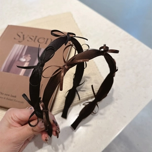 Elegant satin bow headbands in black and brown finish for a minimalist chic hair style