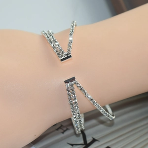 Detailed view of luxury bridal rhinestone crossover open bracelet in silver finish