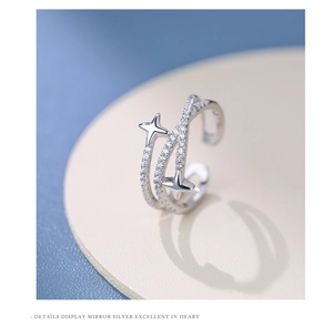 Macro detail of silver S925 multi-layered cross ring with zircon star and mirror finish