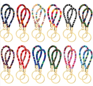 Detail of twelve colorful bohemian woven wristlet keychains with gold metal rings