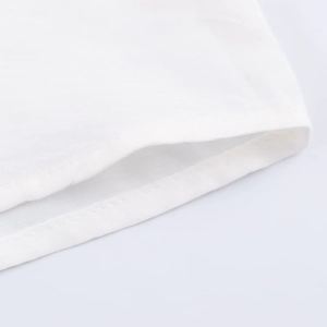 Macro shot of white shirt sleeve cuff showing fine stitching and premium woven fabric