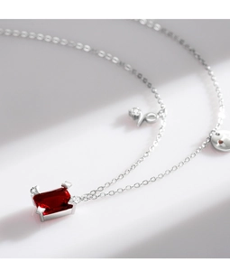 Macro shot of red rectangular zircon pendant with silver S925 sterling silver chain