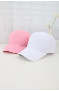 Pink and white minimalist cotton baseball caps displayed on a bright surface