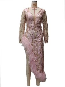 Detail of pink sequins embroidery and soft mesh ruffles on a split evening gown