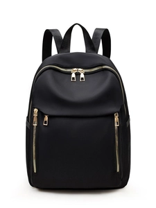Minimalist black nylon backpack with gold zippers and large capacity for women travel