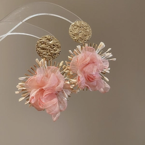 Detail of pink chiffon flower drop earrings with golden hammered metal texture