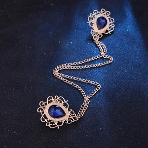 Gold vintage collar chain brooch with blue teardrop gemstones and hollow metal filigree
