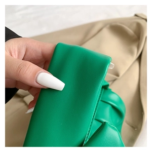 Detailed macro shot of the green ruched PU leather handle on a chic crossbody bag
