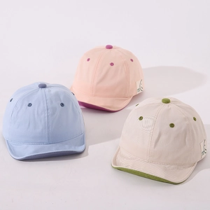 Infant baseball caps with short brim and GOOD LUCK smiley patch in three soft colors