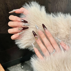 Elegant red tweed press-on nails with pearls and gold gems for a luxury manicure