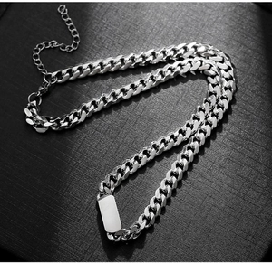 Detail view of silver Cuban chain necklace with minimalist rectangular pendant and lobster clasp