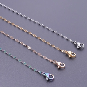 Detail of cross and lip chains in silver, gold, rose gold and rainbow finishes