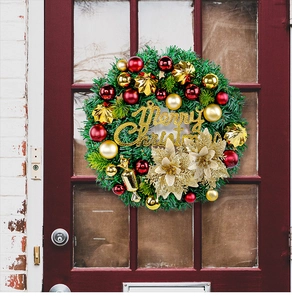 Detailed view of green Christmas wreath with gold flowers and balls on red door
