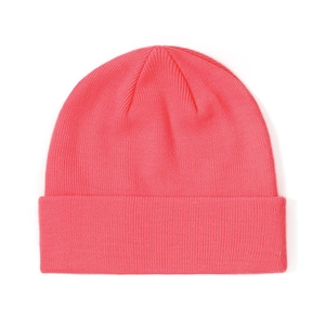 Detailed close-up of coral pink ribbed knit beanie showing fine fabric texture and fold