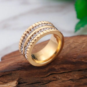 Fashion wide gold ring with double rows of clear zircon on dark wood base