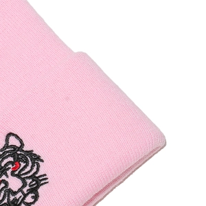 Close-up of pink knitted beanie featuring a detailed cartoon tiger embroidery detail