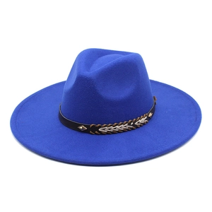 Close-up of klein blue wool fedora hat featuring leather band and gold metal studs