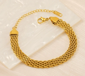 Detail of gold woven stainless steel bracelet with K18 engraving and lobster clasp