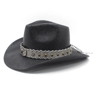 Detail of black woven cowboy hat featuring vintage bull head metal buckle and silver studs