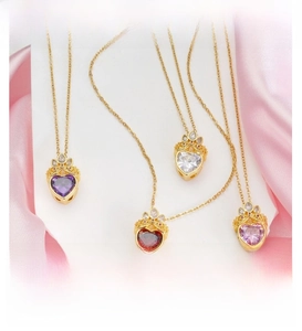Close-up of heart crystal pendant with crown detail in purple, red, white, and pink