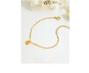 Detail of 18k gold plated chain with round disc pendant and adjustable lobster clasp