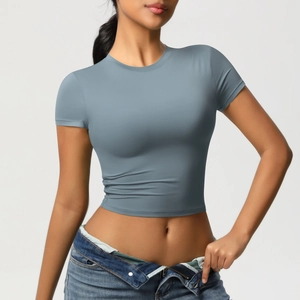 Detail of crop top hem and stretchy blue fabric on casual slim yoga shirt