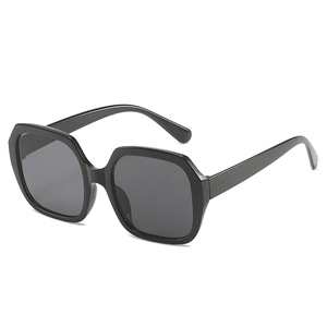 Oversized polygonal sunglasses with black glossy frames and dark grey lenses for fashion