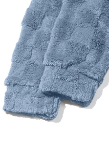 Close-up of the soft blue fleece fabric texture and ribbed cuffs on the hooded sweatshirt
