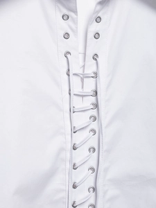 Detailed close-up of white blouse featuring cross-lace design and silver metal eyelets
