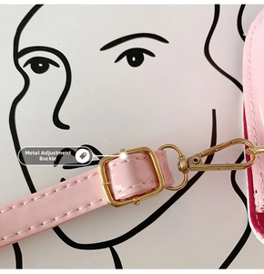 Macro detail of adjustable shoulder strap with gold metal buckle for pink girl's handbag