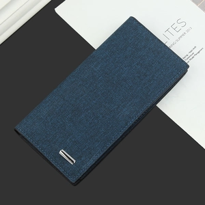 Detail of blue men's long wallet showing woven fabric texture and silver metal plate