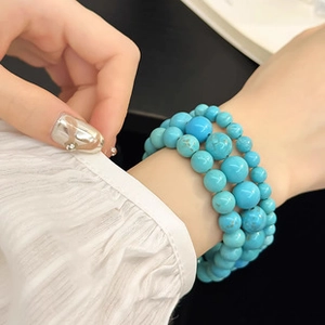 Close-up of sky blue multi-layer beaded turquoise style bracelet on female wrist