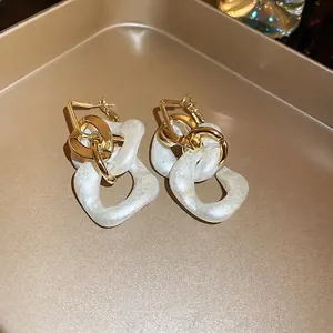 Fashionable gold-tone chain link earrings with white marble acrylic hoops for women