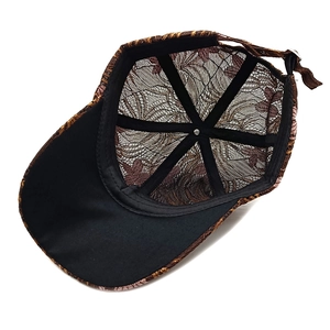 Detail view of lace baseball cap interior with mesh lining and adjustable metal buckle