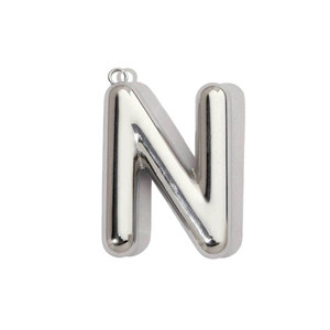 Macro view of polished silver bubble letter N pendant with metallic gloss finish