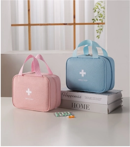 Portable pink and blue first aid bags with zipper handles and medical cross logo