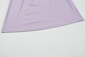 Detail of light purple dress hem showing high-quality stitching and soft jersey fabric