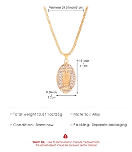 Macro detail of gold-plated alloy American football pendant with white rhinestones