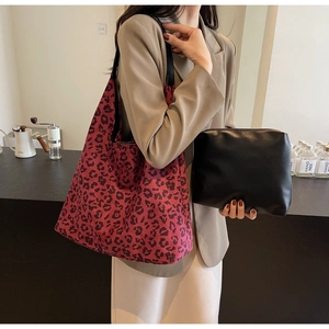 Detail of red leopard print canvas tote with black leather pouch for urban style