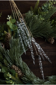 Detail showing twisted transparent acrylic icicle ornaments on brown stems for decor