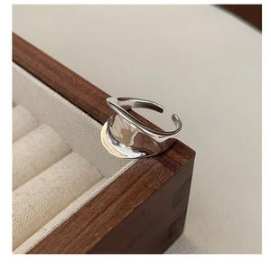 Macro shot of minimalist S925 sterling silver saddle ring with fluid lava texture design