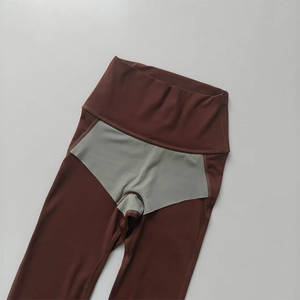 Detail of high-waisted yoga leggings showing the seamless stitching and grey gusset design