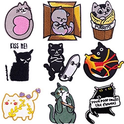 Detailed grid of nine colorful cartoon cat embroidery patches with unique slogans