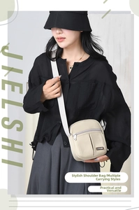 Detail of cream nylon crossbody bag with adjustable wide strap and zip pocket