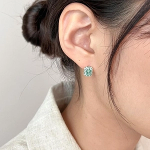 Elegant square green zircon stud earrings in 925 sterling silver worn by a model