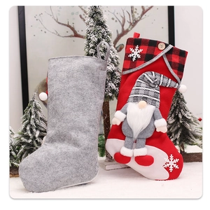 Detailed front and back view of a plush gnome Christmas stocking with red plaid fabric