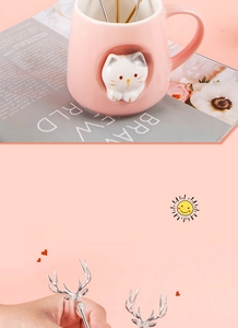 Pink ceramic cat mug detail with silver reindeer horn stainless steel dessert spoon